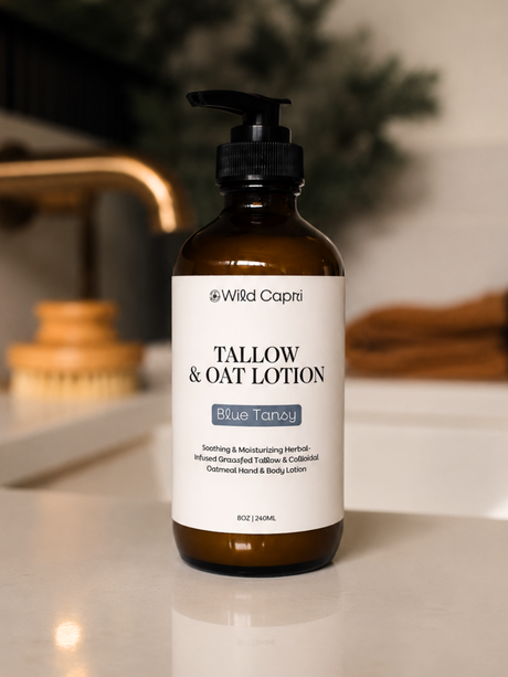 an 8oz bottle of Wild Capri blue tansy tallow & colloidal oat lotion on a festive bathroom counter 